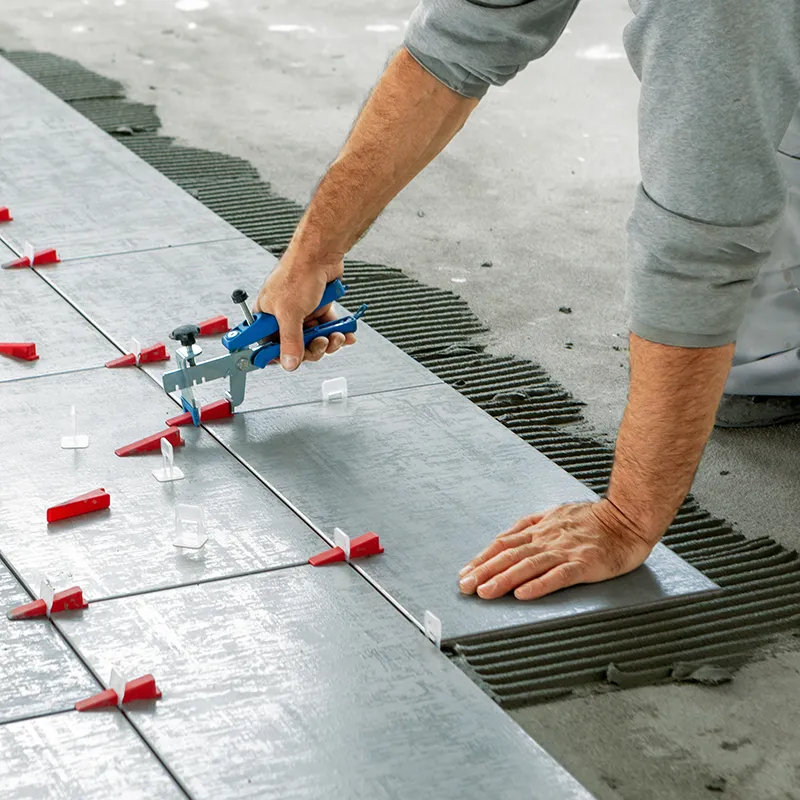 Worker installing tile | In and Out Flooring